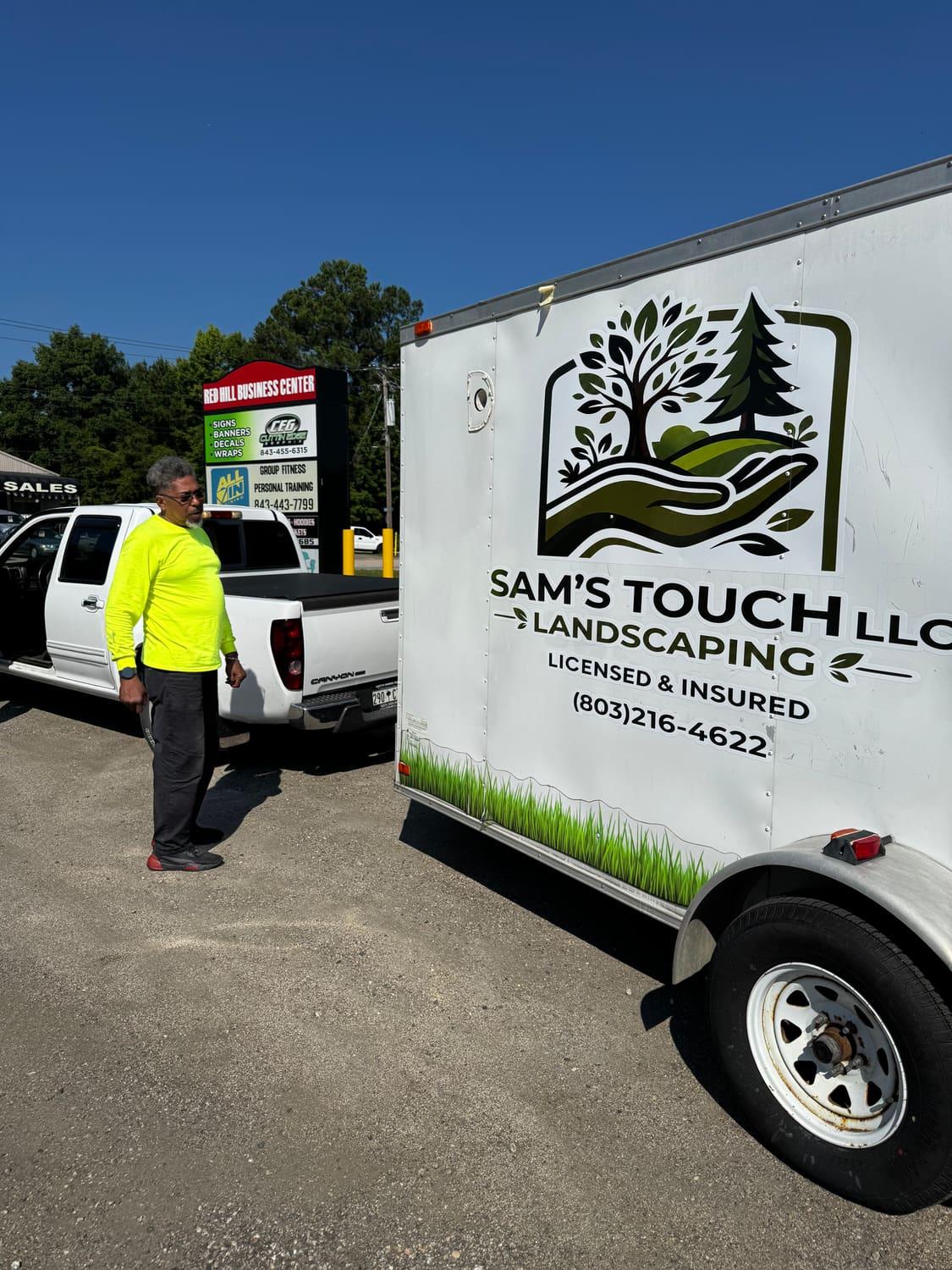 Sam beside the Sam's Touch Landscaping truck and trailer